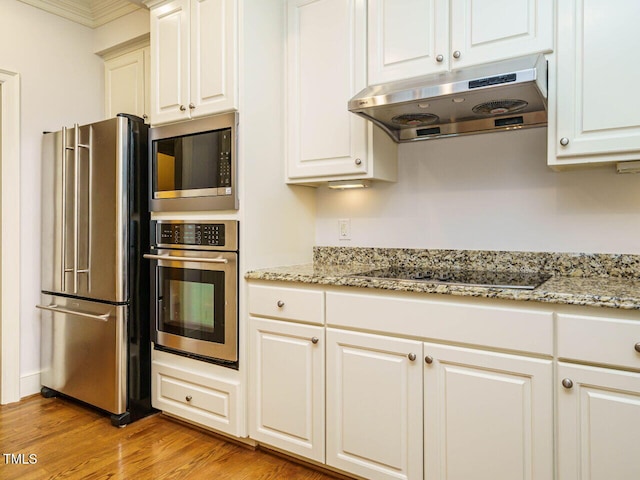 3339 Ridgecrest Ct, Raleigh, NC 27607 - kitchen with appliances with stainless steel finishes, under cabinet range hood, light wood-type flooring, light stone countertops, and white cabinets