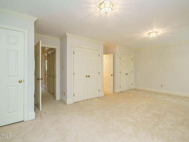 3339 Ridgecrest Ct, Raleigh, NC 27607 - unfurnished bedroom featuring multiple closets, light carpet, and crown molding