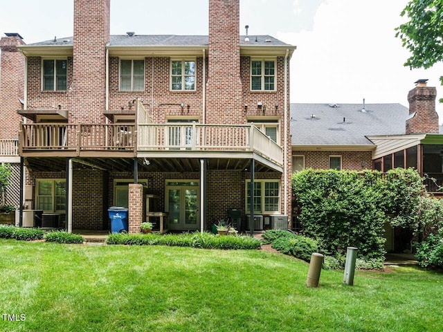 3339 Ridgecrest Ct, Raleigh, NC 27607 - rear view of house featuring brick siding, a lawn, a chimney, and a wooden deck