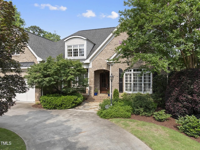 1210 Brooks Ave, Raleigh, NC 27607 - view of front of house featuring brick siding, concrete driveway, roof with shingles, and a garage