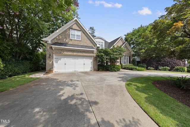 1210 Brooks Ave, Raleigh, NC 27607 - traditional-style house featuring brick siding, driveway, and an attached garage