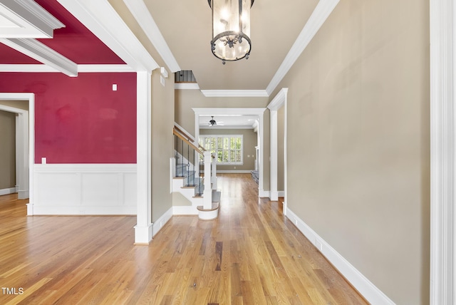 1210 Brooks Ave, Raleigh, NC 27607 - foyer featuring crown molding, stairway, a chandelier, wood finished floors, and ceiling fan