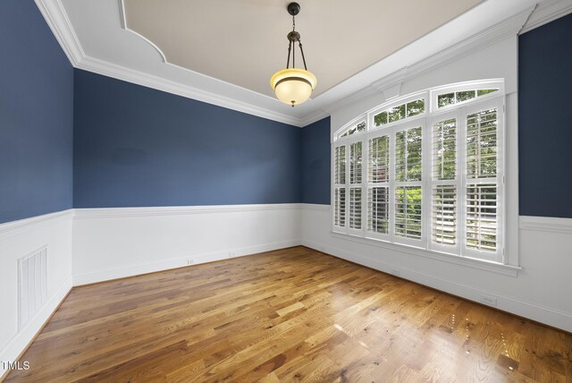 1210 Brooks Ave, Raleigh, NC 27607 - empty room featuring healthy amount of natural light, wood finished floors, and crown molding