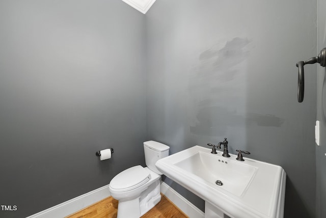 1210 Brooks Ave, Raleigh, NC 27607 - half bath with toilet, wood finished floors, baseboards, and crown molding