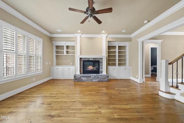 1210 Brooks Ave, Raleigh, NC 27607 - unfurnished living room with ornamental molding, a stone fireplace, stairway, ceiling fan, and wood finished floors