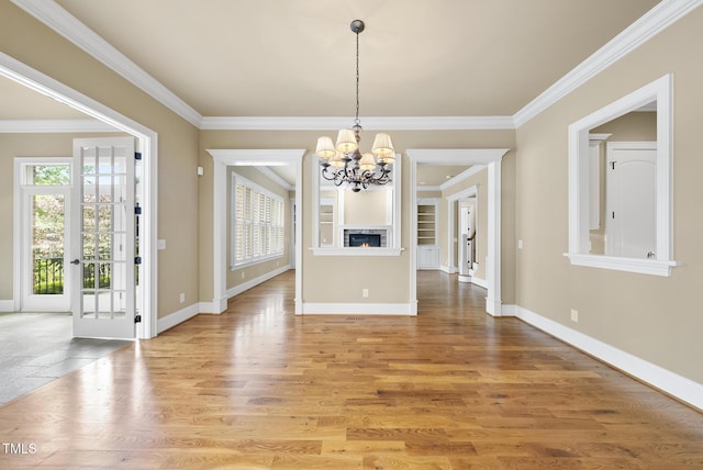 1210 Brooks Ave, Raleigh, NC 27607 - unfurnished dining area with a chandelier, crown molding, baseboards, and light wood-style flooring