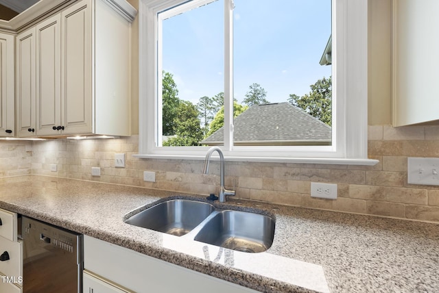 1210 Brooks Ave, Raleigh, NC 27607 - kitchen with dishwasher, a sink, backsplash, and light stone counters