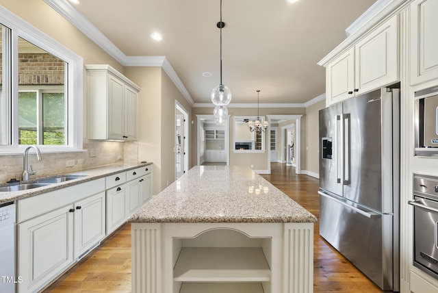 1210 Brooks Ave, Raleigh, NC 27607 - kitchen with stainless steel appliances, a sink, a chandelier, light wood finished floors, and decorative backsplash