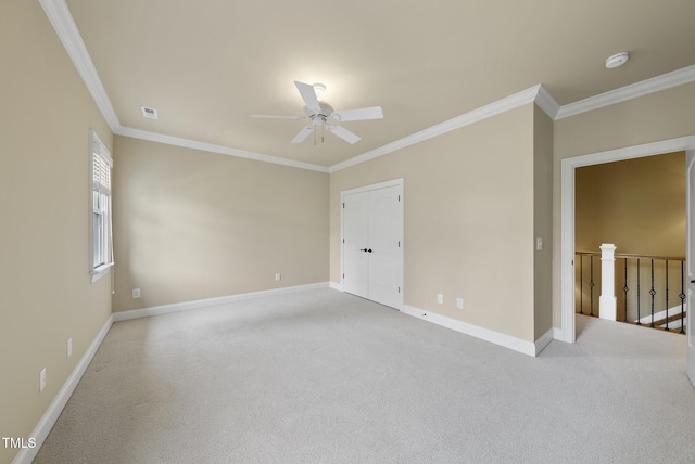 1210 Brooks Ave, Raleigh, NC 27607 - empty room with crown molding, ceiling fan, baseboards, light colored carpet, and a smoke detector