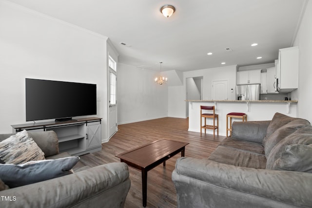 1728 Shady Oaks Dr, Wendell, NC 27591 - living room featuring a chandelier, recessed lighting, wood finished floors, baseboards, and ornamental molding