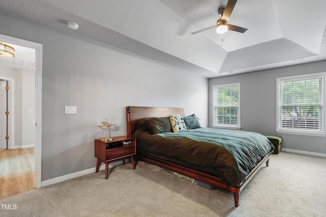 202 Stonecreek Dr, Apex, NC 27539 - bedroom featuring a raised ceiling, light carpet, and baseboards