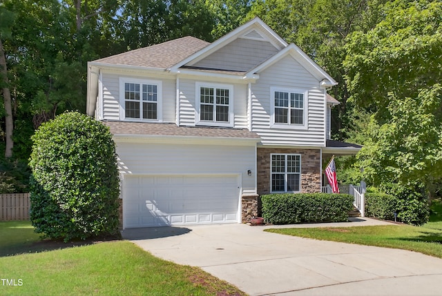 1437 Lindenberg Sq, Wake Forest, NC 27587 - view of front of house featuring driveway, a garage, stone siding, and a shingled roof