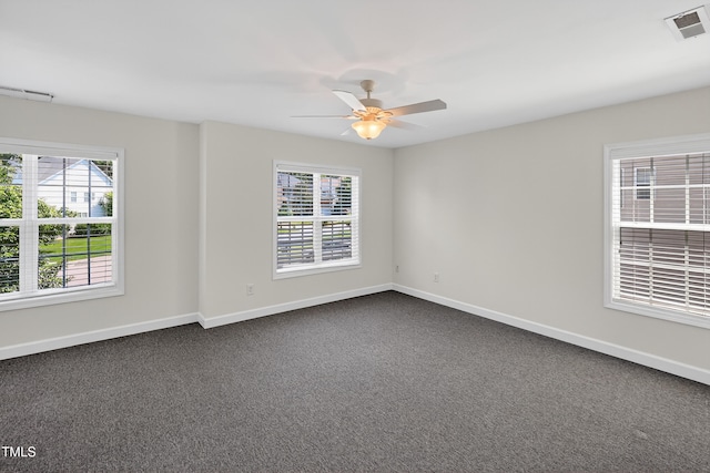1437 Lindenberg Sq, Wake Forest, NC 27587 - spare room with plenty of natural light, a ceiling fan, and dark colored carpet