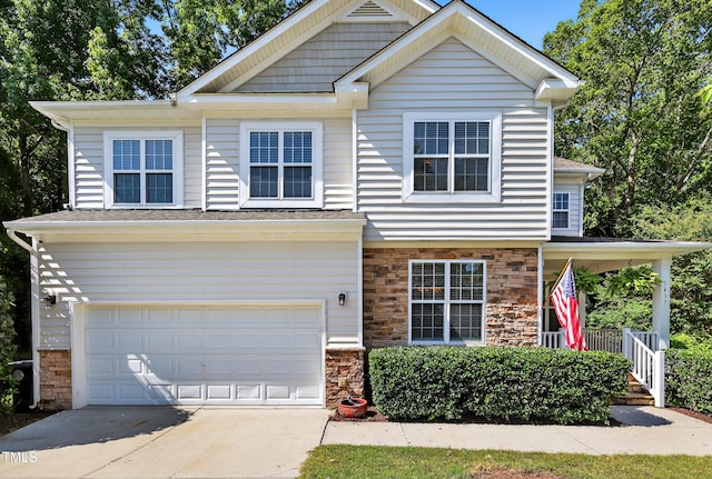 1437 Lindenberg Sq, Wake Forest, NC 27587 - view of front of home featuring an attached garage, stone siding, concrete driveway, and a porch