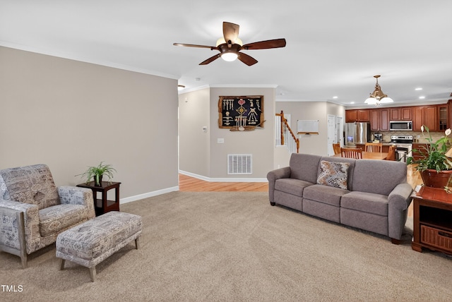 1437 Lindenberg Sq, Wake Forest, NC 27587 - living room with light carpet, recessed lighting, a chandelier, ceiling fan, and ornamental molding
