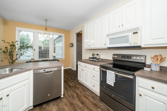 6737 Vernie Dr, Raleigh, NC 27603 - kitchen featuring appliances with stainless steel finishes, dark countertops, and white cabinets