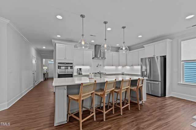 2012 Sweet Samson St, Wake Forest, NC 27587 - kitchen with appliances with stainless steel finishes, ornamental molding, wall chimney range hood, baseboards, and light countertops