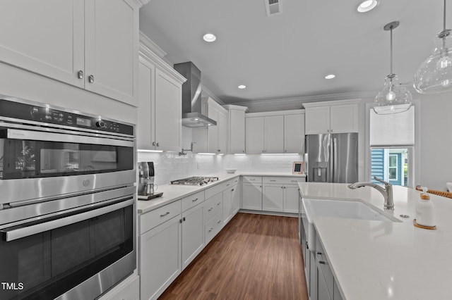 2012 Sweet Samson St, Wake Forest, NC 27587 - kitchen with stainless steel appliances, wall chimney range hood, light countertops, white cabinetry, and decorative backsplash