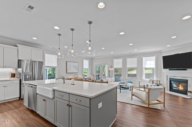 2012 Sweet Samson St, Wake Forest, NC 27587 - kitchen featuring open floor plan, dishwasher, a sink, ornamental molding, and light countertops