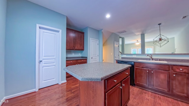 151 Braeside Ct, Cary, NC 27519 - kitchen featuring a sink, dishwasher, a kitchen island, wood finished floors, and ceiling fan