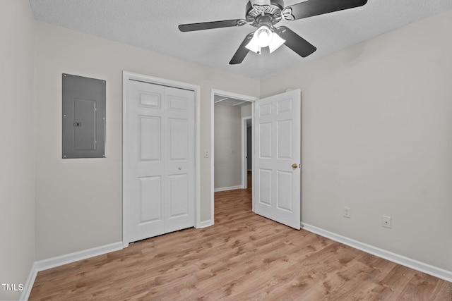 428 Long Branch Dr, Lacrosse, VA 23950 - unfurnished bedroom with electric panel, light wood-type flooring, baseboards, a closet, and a textured ceiling