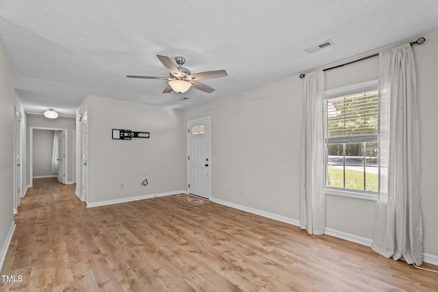 428 Long Branch Dr, Lacrosse, VA 23950 - spare room featuring a textured ceiling, a ceiling fan, light wood-type flooring, and baseboards