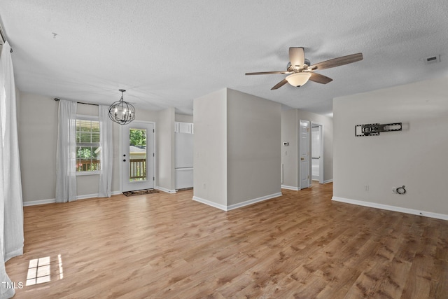 428 Long Branch Dr, Lacrosse, VA 23950 - unfurnished living room with a textured ceiling, a ceiling fan, light wood-style flooring, a chandelier, and baseboards