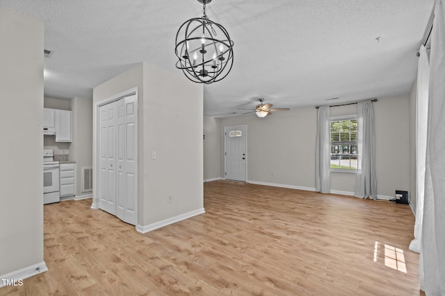 428 Long Branch Dr, Lacrosse, VA 23950 - unfurnished living room with a textured ceiling, ceiling fan, light wood finished floors, baseboards, and a chandelier