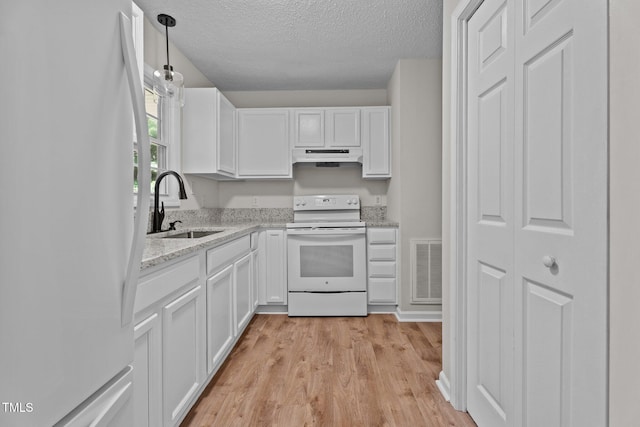428 Long Branch Dr, Lacrosse, VA 23950 - kitchen with white appliances, a sink, under cabinet range hood, a textured ceiling, and white cabinetry