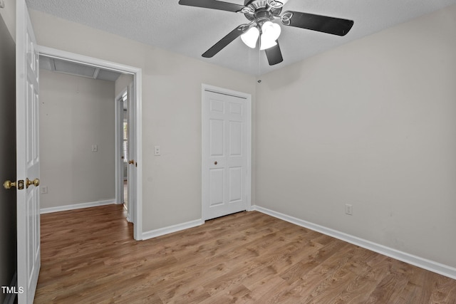 428 Long Branch Dr, Lacrosse, VA 23950 - unfurnished bedroom with attic access, light wood-type flooring, baseboards, a ceiling fan, and a textured ceiling