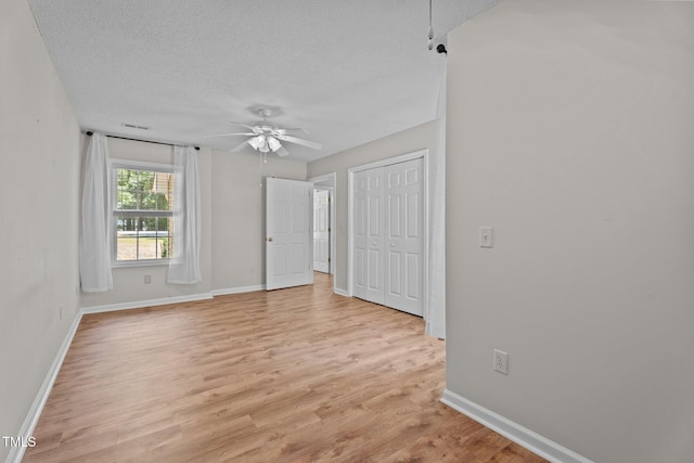 428 Long Branch Dr, Lacrosse, VA 23950 - empty room featuring ceiling fan, a textured ceiling, baseboards, and light wood finished floors
