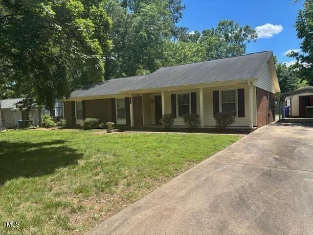 708 Old Barn Ave, Durham, NC 27704 - ranch-style house with concrete driveway, a front lawn, and covered porch