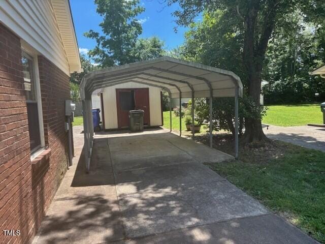 708 Old Barn Ave, Durham, NC 27704 - view of parking featuring a detached carport and concrete driveway