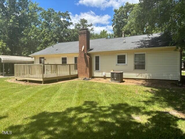 708 Old Barn Ave, Durham, NC 27704 - back of house featuring a wooden deck, a chimney, a lawn, and cooling unit