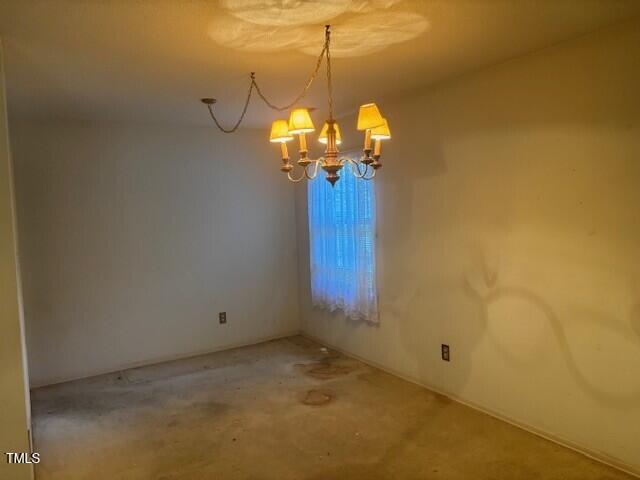 708 Old Barn Ave, Durham, NC 27704 - unfurnished room featuring a chandelier