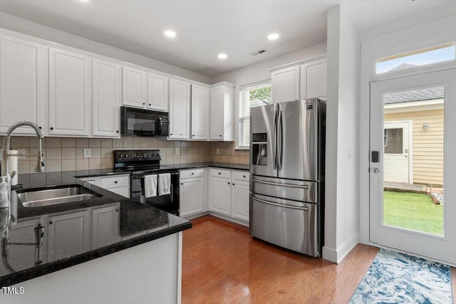 4605 All Points View Way, Raleigh, NC 27614 - kitchen featuring black appliances, a sink, white cabinets, wood finished floors, and decorative backsplash