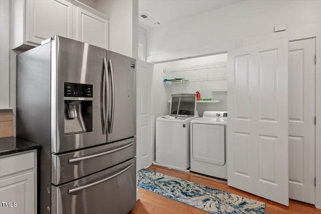 4605 All Points View Way, Raleigh, NC 27614 - kitchen featuring stainless steel fridge, washer and clothes dryer, light wood-type flooring, and white cabinetry