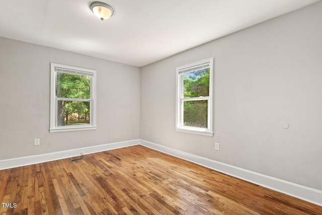 1411 Hudson Ave, Durham, NC 27705 - empty room featuring healthy amount of natural light, baseboards, and wood finished floors