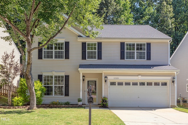 12320 Tetons Ct, Durham, NC 27703 - view of front of home with driveway, a front yard, an attached garage, and a shingled roof