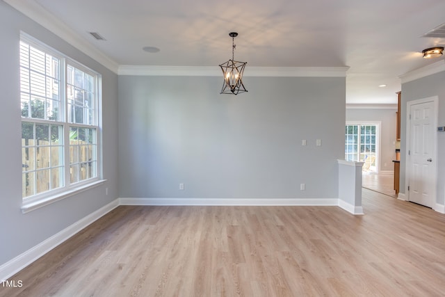 12320 Tetons Ct, Durham, NC 27703 - unfurnished room featuring ornamental molding, light wood-style floors, and a chandelier