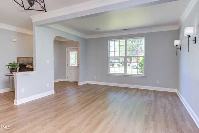 12320 Tetons Ct, Durham, NC 27703 - unfurnished living room with arched walkways, plenty of natural light, wood finished floors, crown molding, and a chandelier