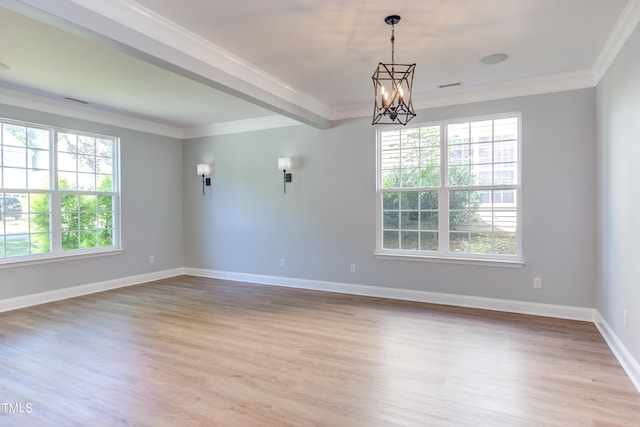 12320 Tetons Ct, Durham, NC 27703 - spare room featuring healthy amount of natural light, a chandelier, light wood-type flooring, and crown molding