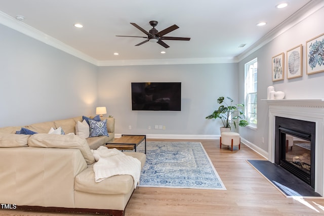 12320 Tetons Ct, Durham, NC 27703 - living room featuring ceiling fan, wood finished floors, recessed lighting, ornamental molding, and a glass covered fireplace