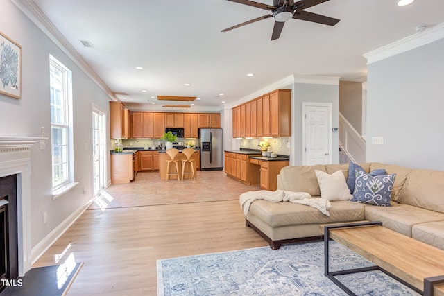 12320 Tetons Ct, Durham, NC 27703 - living area with crown molding, recessed lighting, a fireplace, plenty of natural light, and ceiling fan