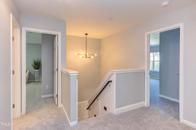 12320 Tetons Ct, Durham, NC 27703 - hallway featuring an upstairs landing, light colored carpet, and a chandelier