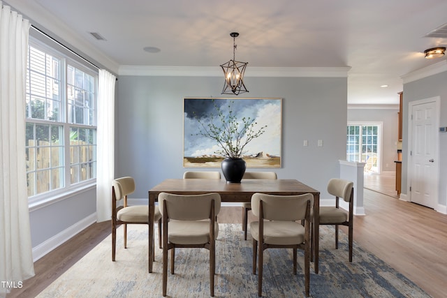 12320 Tetons Ct, Durham, NC 27703 - dining space with crown molding and wood finished floors