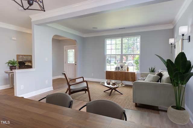 12320 Tetons Ct, Durham, NC 27703 - living area with arched walkways, light wood-style floors, and crown molding