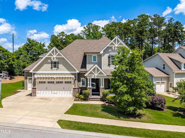 2538 Tuffeto, Apex, NC 27502 - craftsman-style home with stone siding, concrete driveway, a front yard, a garage, and roof with shingles