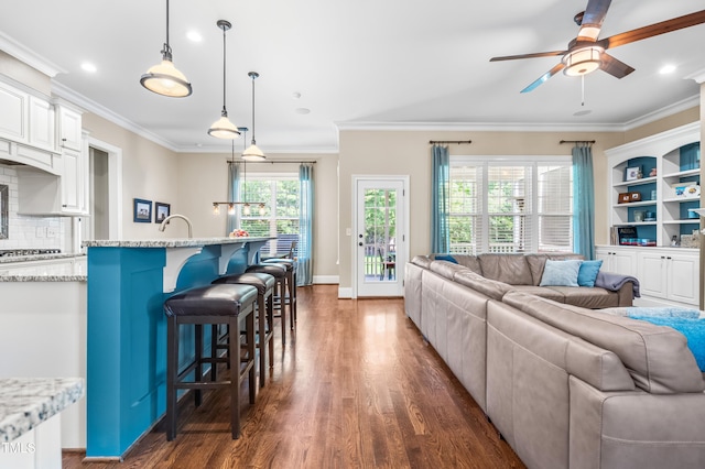 2538 Tuffeto, Apex, NC 27502 - living room featuring dark wood-style floors, a ceiling fan, ornamental molding, recessed lighting, and baseboards