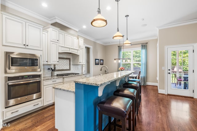 2538 Tuffeto, Apex, NC 27502 - kitchen featuring appliances with stainless steel finishes, dark wood finished floors, decorative backsplash, ornamental molding, and light stone countertops